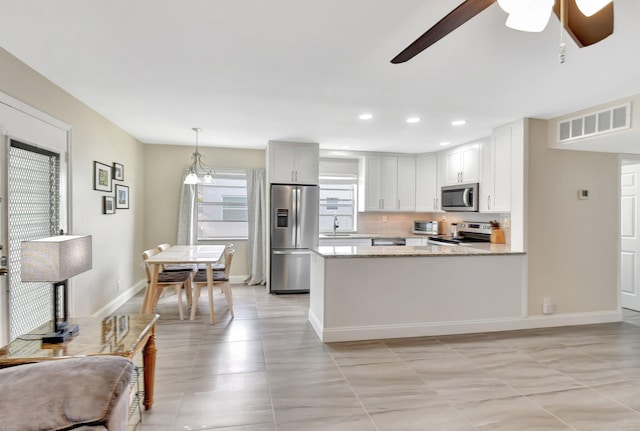 kitchen featuring recessed lighting, stainless steel appliances, visible vents, a peninsula, and ceiling fan