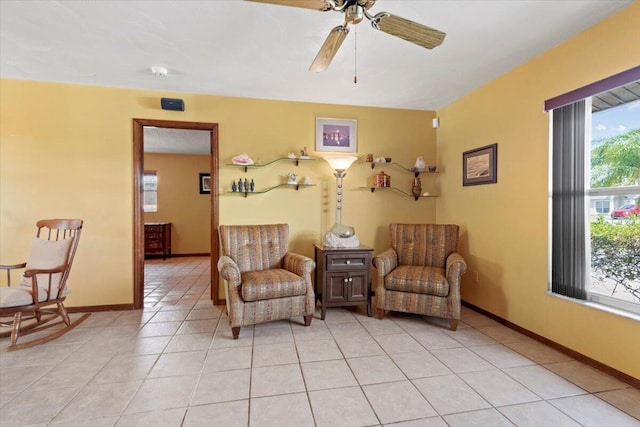 sitting room featuring light tile patterned floors, ceiling fan, and baseboards