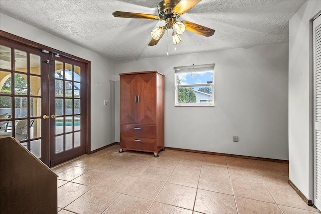 doorway to outside featuring a wealth of natural light, french doors, a textured ceiling, and baseboards