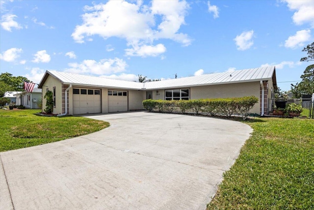 ranch-style home with fence, metal roof, driveway, a front lawn, and an attached garage