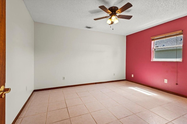 unfurnished room with a textured ceiling, visible vents, and ceiling fan