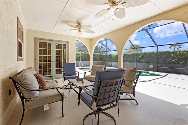 view of patio / terrace with french doors, glass enclosure, a ceiling fan, and a fenced in pool