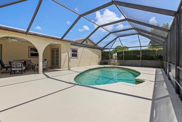 pool with a patio, outdoor lounge area, ceiling fan, and a lanai