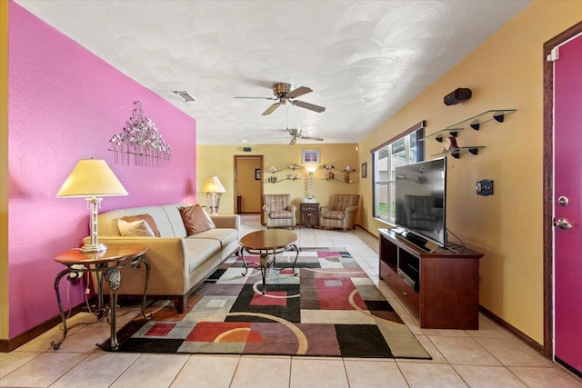 tiled living room with visible vents, a ceiling fan, and baseboards