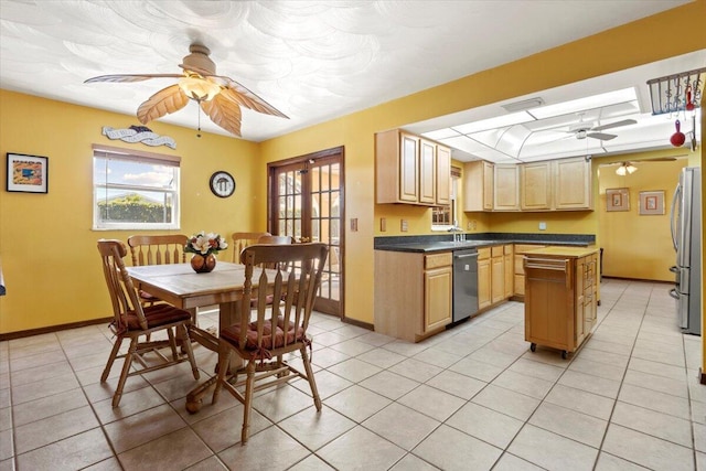 kitchen featuring ceiling fan, light brown cabinets, stainless steel appliances, a center island, and light tile patterned flooring