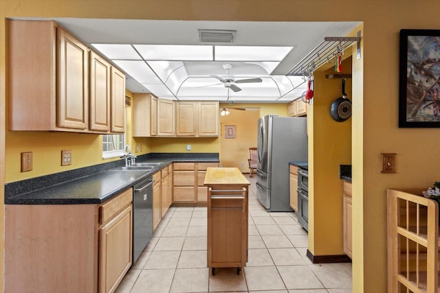 kitchen with a sink, light brown cabinetry, a ceiling fan, visible vents, and dishwasher