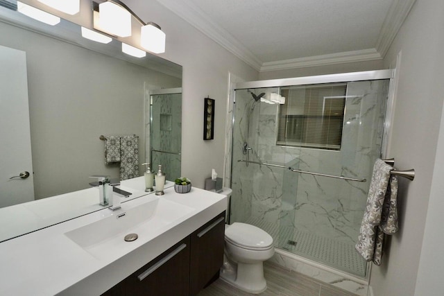full bathroom with a marble finish shower, toilet, crown molding, and vanity
