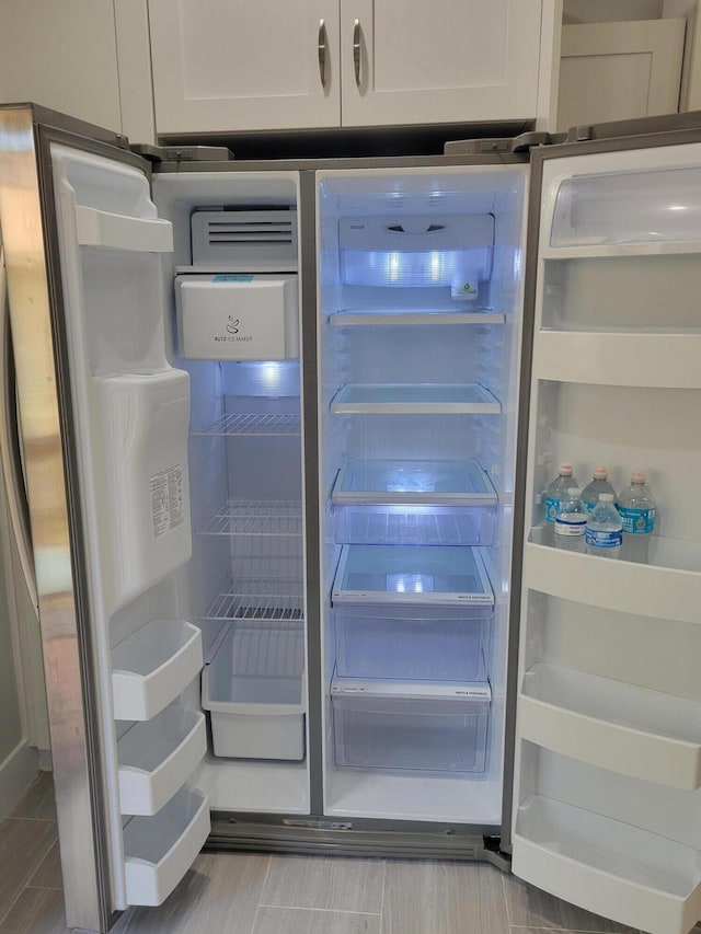 interior details with refrigerator with glass door