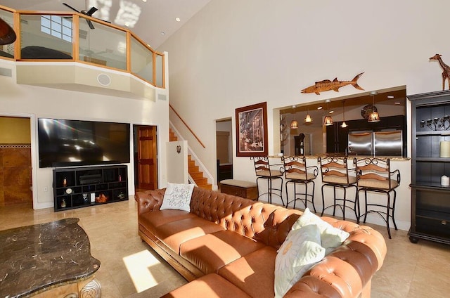 283 NE Sagamore Terrace, Port Saint Lucie, FL 34983 - tiled living area featuring high vaulted ceiling, stairway, and visible vents