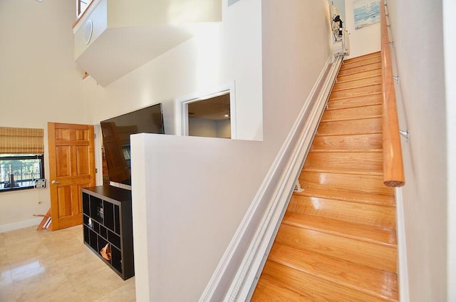 283 NE Sagamore Terrace, Port Saint Lucie, FL 34983 - stairs with tile patterned flooring, a high ceiling, and baseboards