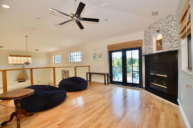 283 NE Sagamore Terrace, Port Saint Lucie, FL 34983 - sitting room with ceiling fan, vaulted ceiling, wood finished floors, and a fireplace