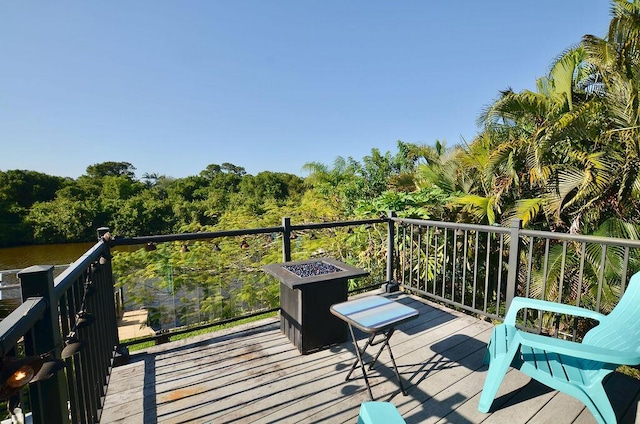283 NE Sagamore Terrace, Port Saint Lucie, FL 34983 - wooden terrace with a water view and a fire pit