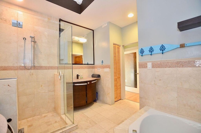 283 NE Sagamore Terrace, Port Saint Lucie, FL 34983 - full bath with tile walls, a shower stall, vanity, tile patterned floors, and a garden tub