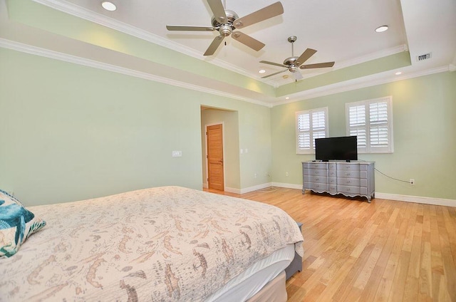 283 NE Sagamore Terrace, Port Saint Lucie, FL 34983 - bedroom with visible vents, ornamental molding, light wood-style flooring, and a tray ceiling