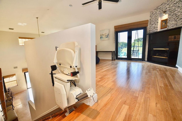 283 NE Sagamore Terrace, Port Saint Lucie, FL 34983 - unfurnished living room with plenty of natural light, a ceiling fan, baseboards, and light wood-type flooring
