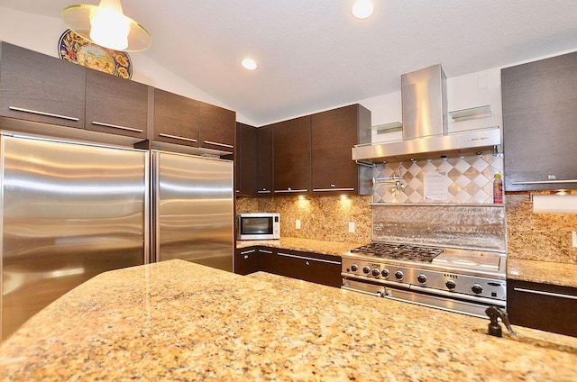 283 NE Sagamore Terrace, Port Saint Lucie, FL 34983 - kitchen featuring island exhaust hood, built in refrigerator, light stone counters, backsplash, and vaulted ceiling