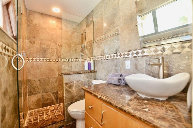 283 NE Sagamore Terrace, Port Saint Lucie, FL 34983 - bathroom featuring tile walls, a walk in shower, toilet, and vanity