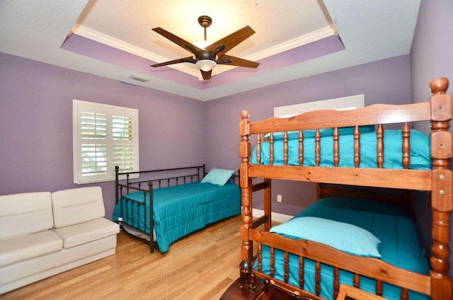 283 NE Sagamore Terrace, Port Saint Lucie, FL 34983 - bedroom featuring crown molding, wood finished floors, and a raised ceiling