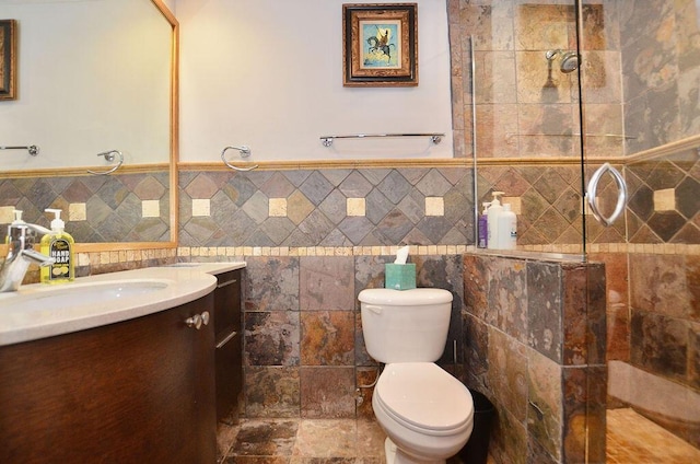 283 NE Sagamore Terrace, Port Saint Lucie, FL 34983 - full bathroom with toilet, a tile shower, tile walls, and vanity