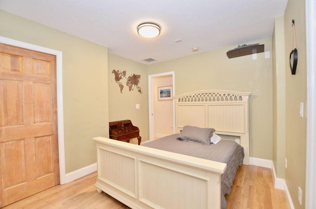 283 NE Sagamore Terrace, Port Saint Lucie, FL 34983 - bedroom featuring visible vents, light wood finished floors, and baseboards