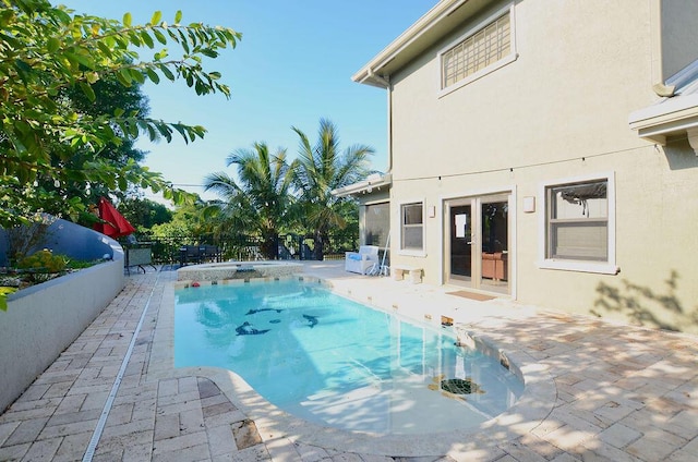 283 NE Sagamore Terrace, Port Saint Lucie, FL 34983 - view of pool featuring a fenced in pool, a patio area, an in ground hot tub, and a fenced backyard
