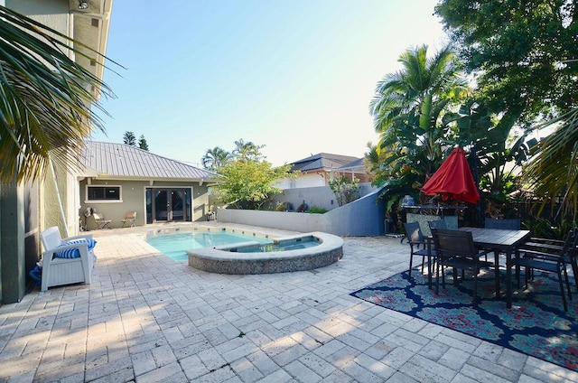 283 NE Sagamore Terrace, Port Saint Lucie, FL 34983 - view of pool with a fenced in pool, a patio area, an in ground hot tub, and a fenced backyard