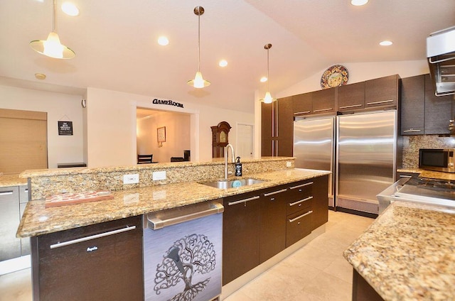 283 NE Sagamore Terrace, Port Saint Lucie, FL 34983 - kitchen with a sink, stainless steel appliances, pendant lighting, dark brown cabinets, and lofted ceiling