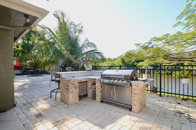 283 NE Sagamore Terrace, Port Saint Lucie, FL 34983 - view of patio / terrace with an outdoor kitchen, outdoor wet bar, a grill, and fence