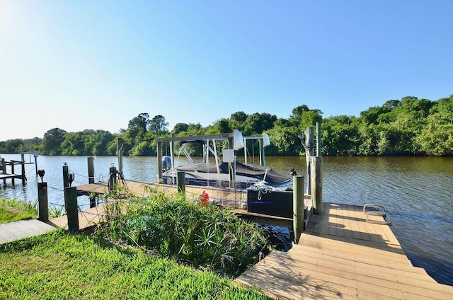 283 NE Sagamore Terrace, Port Saint Lucie, FL 34983 - dock area featuring boat lift and a water view