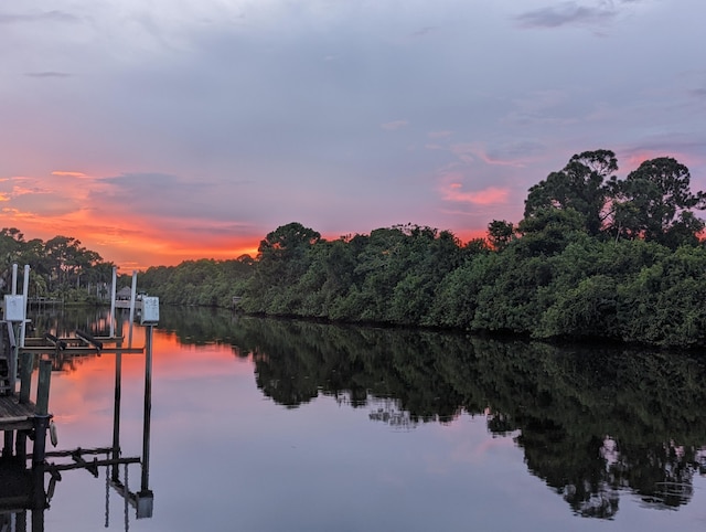283 NE Sagamore Terrace, Port Saint Lucie, FL 34983 - view of water feature featuring boat lift, a boat dock, and a wooded view