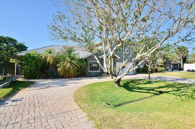 283 NE Sagamore Terrace, Port Saint Lucie, FL 34983 - view of front facade with a front yard and curved driveway