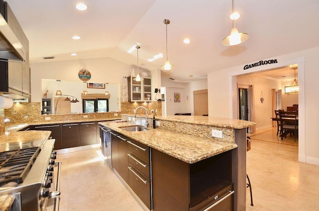 283 NE Sagamore Terrace, Port Saint Lucie, FL 34983 - kitchen featuring high end range, backsplash, lofted ceiling, and a sink