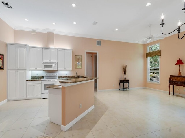 kitchen featuring visible vents, ornamental molding, ceiling fan, and white appliances