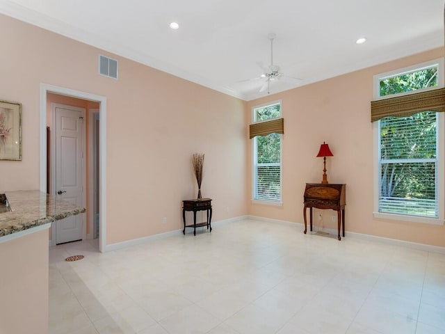 unfurnished room featuring plenty of natural light, baseboards, ceiling fan, and visible vents