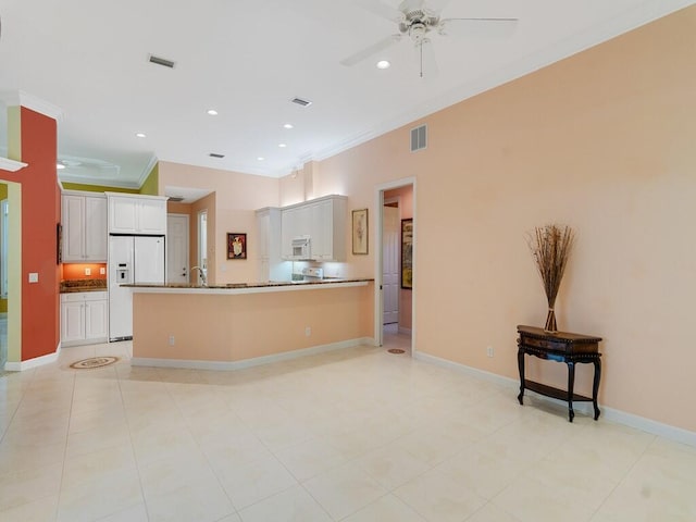 kitchen with white appliances, a ceiling fan, visible vents, and ornamental molding