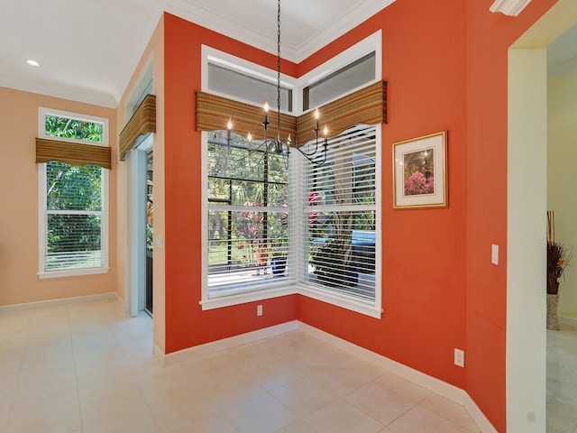 unfurnished dining area featuring crown molding and baseboards