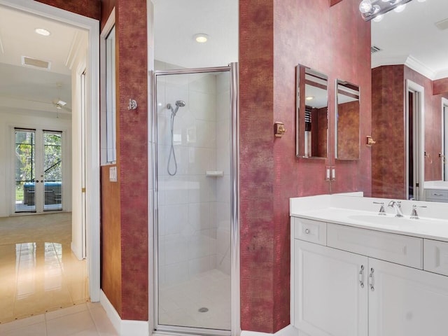 bathroom with vanity, tile patterned floors, baseboards, ornamental molding, and a stall shower