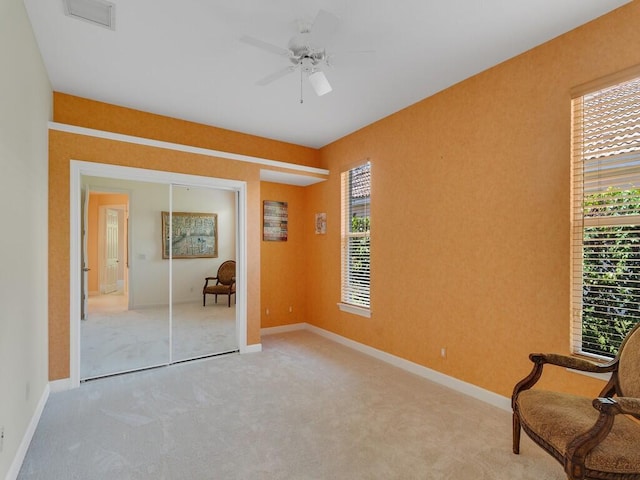 unfurnished room with baseboards, carpet, a ceiling fan, and visible vents