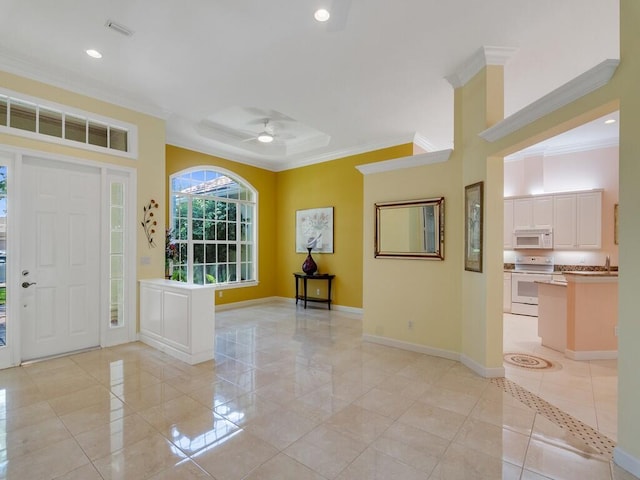 entryway with baseboards, ceiling fan, ornamental molding, and light tile patterned floors