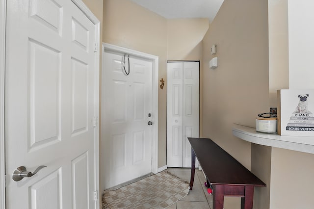 entrance foyer with baseboards and light tile patterned floors