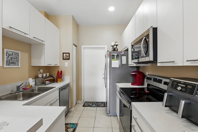 kitchen with white cabinets, light countertops, a sink, and appliances with stainless steel finishes