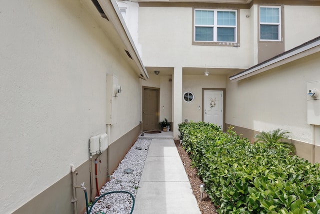 entrance to property featuring stucco siding