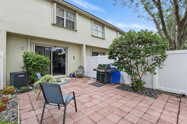 view of patio with a fenced backyard, central AC, and area for grilling