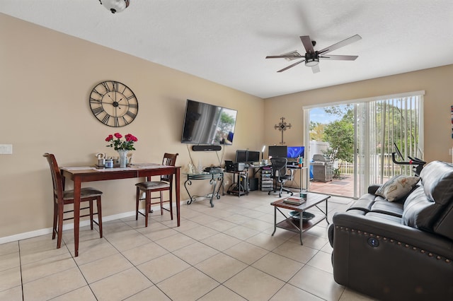 living area featuring a ceiling fan and tile patterned floors