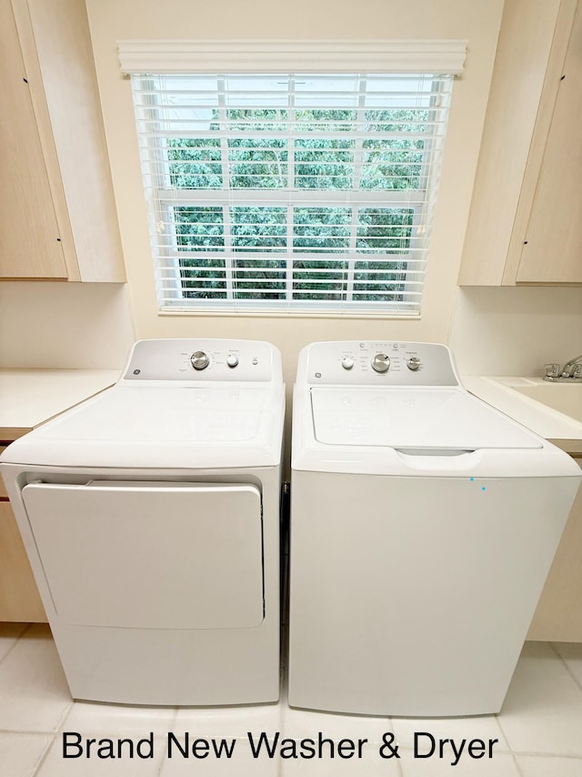 8365 SE Double Tree Dr, Hobe Sound, FL 33455 - laundry room with plenty of natural light, washer and clothes dryer, cabinet space, and tile patterned flooring
