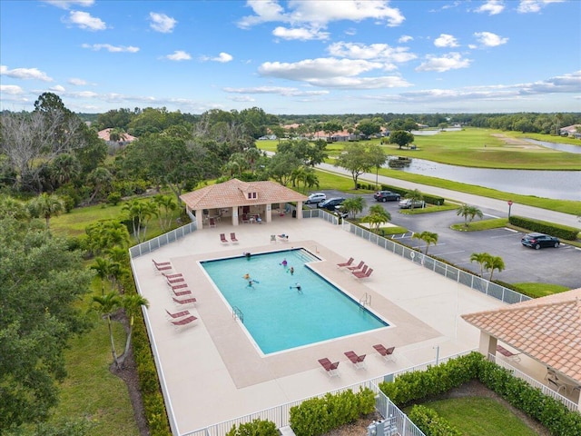 8365 SE Double Tree Dr, Hobe Sound, FL 33455 - community pool featuring a patio area, fence, a water view, and view of wooded area