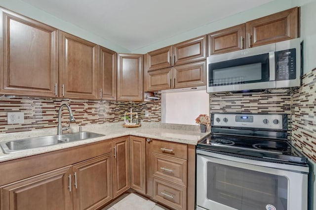176 Lake Carol Dr, West Palm Beach, FL 33411 - kitchen with backsplash, light tile patterned floors, stainless steel appliances, and a sink