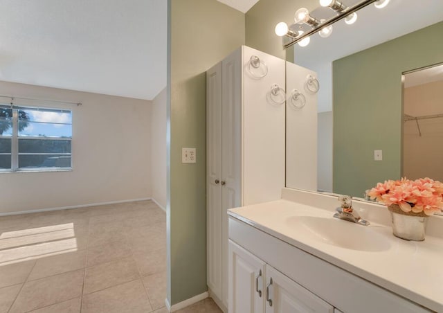 176 Lake Carol Dr, West Palm Beach, FL 33411 - bathroom featuring baseboards, vanity, tile patterned floors, and a closet