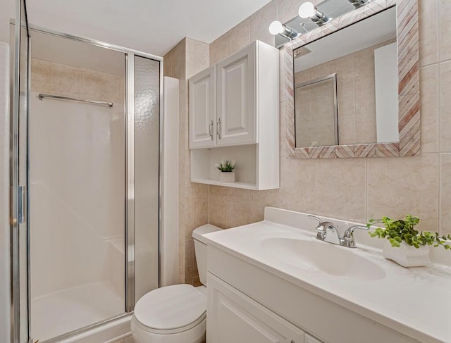 176 Lake Carol Dr, West Palm Beach, FL 33411 - bathroom with tile walls, toilet, vanity, and a stall shower