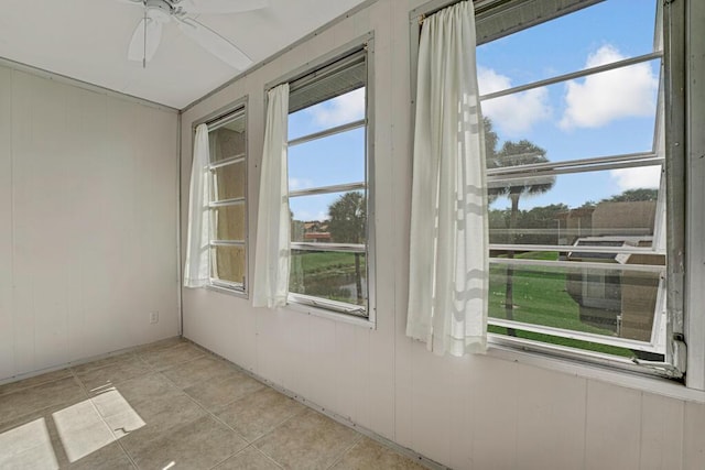 176 Lake Carol Dr, West Palm Beach, FL 33411 - unfurnished room with a ceiling fan, wood walls, and light tile patterned floors